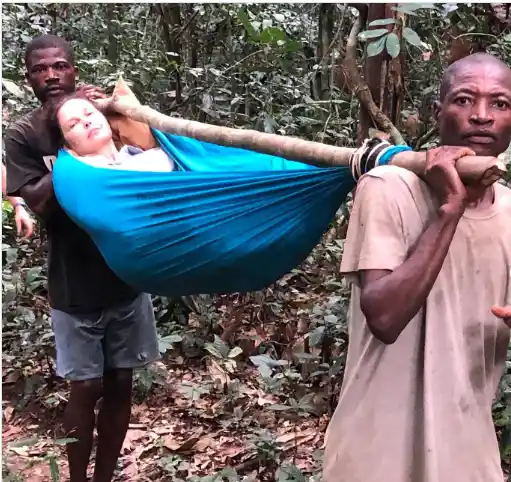Ashley Judd being carried in a hammock through the Congo jungle after her leg injury.