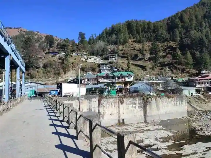 Bridge and dam reservoir leading into Barot Valley village