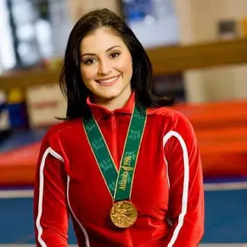 Gymnast Dominique Moceanu wearing her 1996 Olympic gold medal.