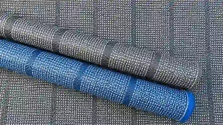 Rolled Arisol Standard woven awning carpets in grey and blue.