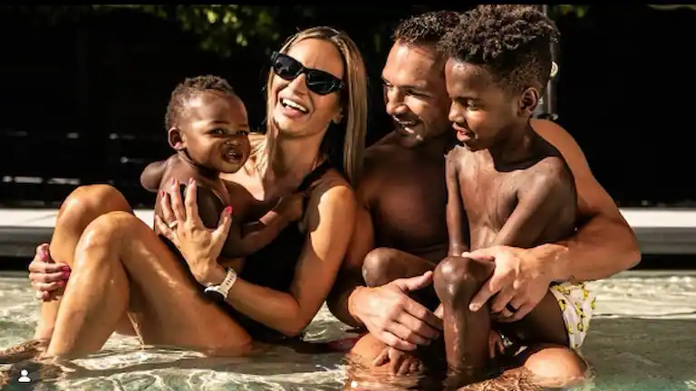 Dr. Brie Willett and husband Michael Chandler enjoying pool time with their sons, Hap and Ace.