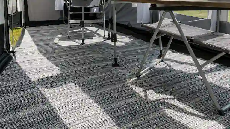 Dometic Continental heavy-duty awning carpet supporting metal camping furniture.