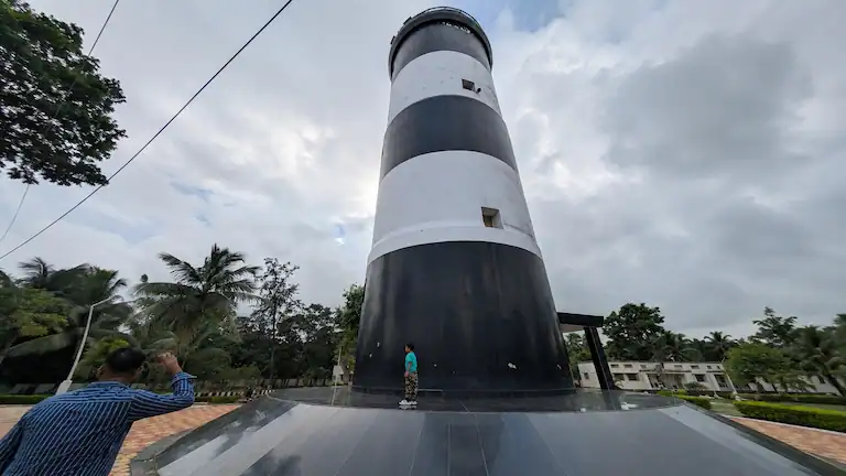 Low angle view of the 96-foot tall black and white striped Dariapur Lighthouse near Bankiput Sea Beach.