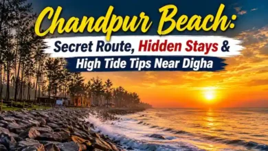 Protective boulders at Chandpur Beach during sunset with crashing waves near Digha.