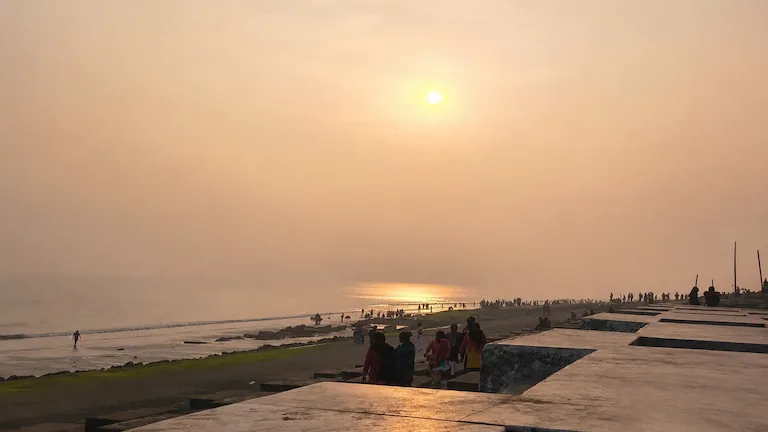 Golden sunset over the Bay of Bengal and concrete embankment at Chandpur Beach